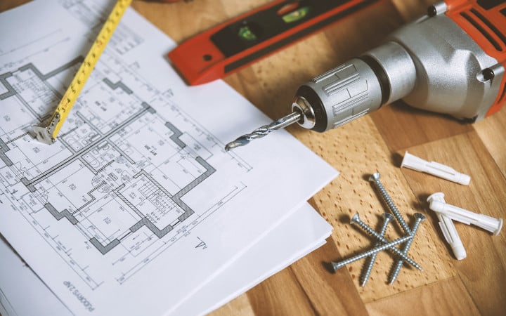 Plan de maison avec perceuse avant le début de la construction